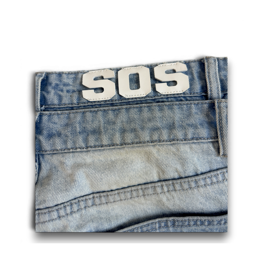 saintsofsummer DIRTY denim jeans featuring a custom faded light blue wash and a white SOS leather patch on the waist