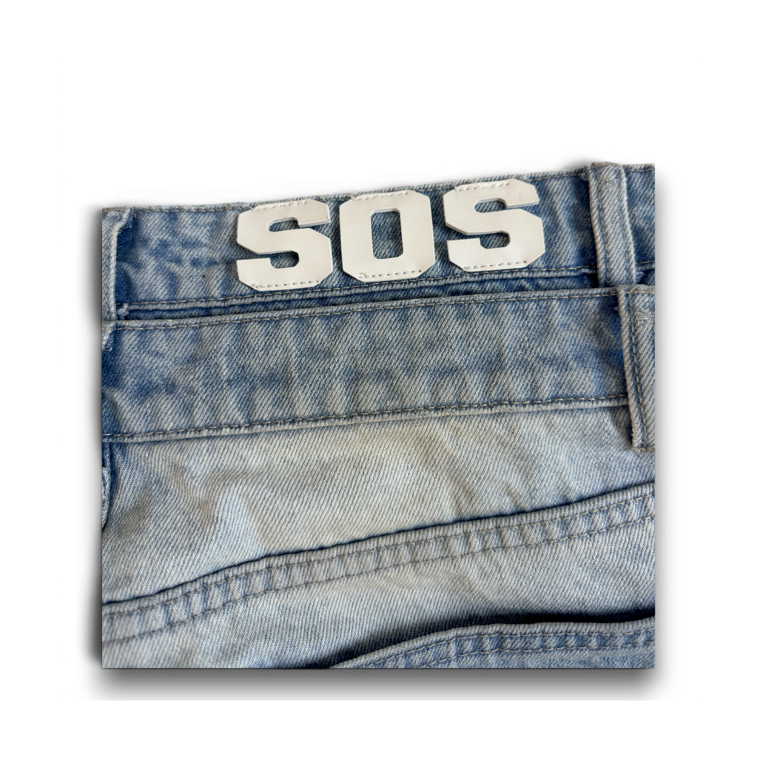 saintsofsummer DIRTY denim jeans featuring a custom faded light blue wash and a white SOS leather patch on the waist