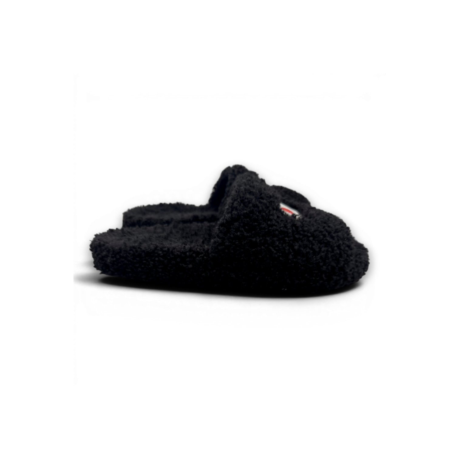 A single black fuzzy slip-on slight with a small red and white logo tab on the side, photographed on a white background.