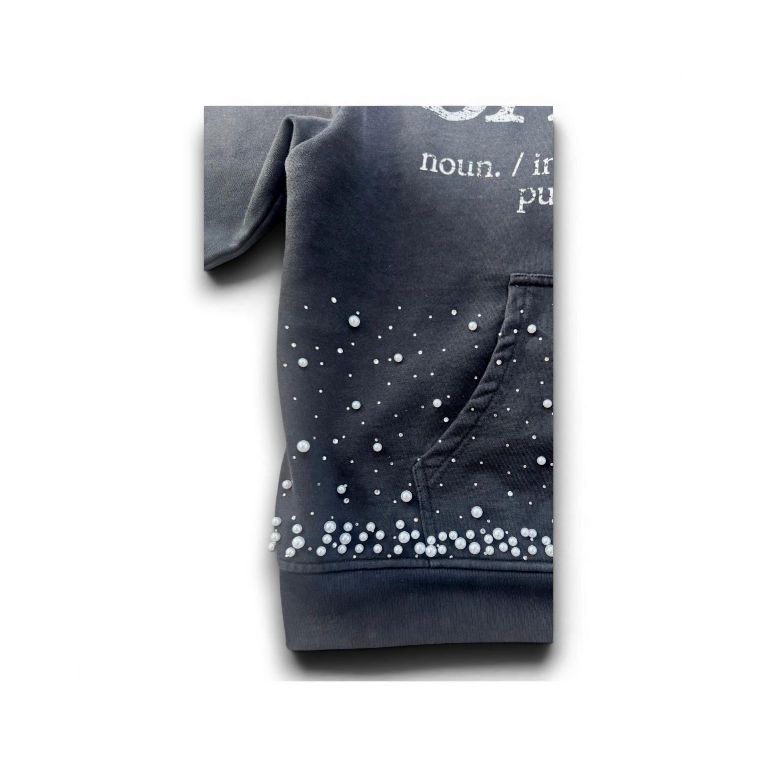 A close-up of a dark gray hoodie featuring white printed text and a pattern of small white dots resembling stars or bubbles, shown on a plain white background.