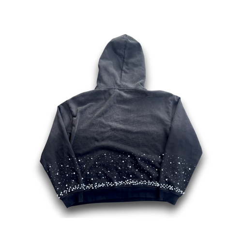 A dark gray and black gradient hoodie with a starry pattern along the hem, shown from the back against a black background.